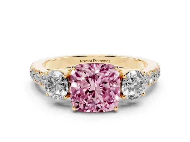 Fancy Pink Cushion Cut Diamond Three-Stone Ring Set in Yellow gold with Round Side Stones and Delicate Pavé Band