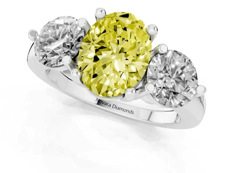Fancy Yellow Oval Cut Diamond Three-Stone Ring Set in White gold with Prong Setting and Classic Band