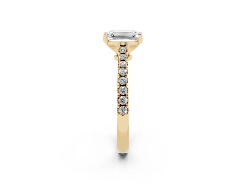 Emerald Cut Diamond Solitaire Engagement Ring Set in Yellow gold with Delicate Pavé Band and Prong Setting