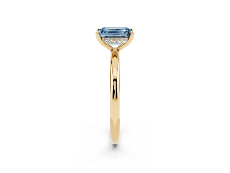 Fancy Blue Emerald Cut Diamond Solitaire Ring Set in Yellow gold with Thin Band and Prong Setting