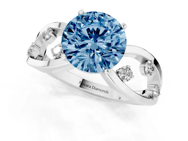 Fancy Blue Round Cut Diamond Solitaire Ring Set in White gold with Side Stones on Criss-Cross Band and Prong Setting