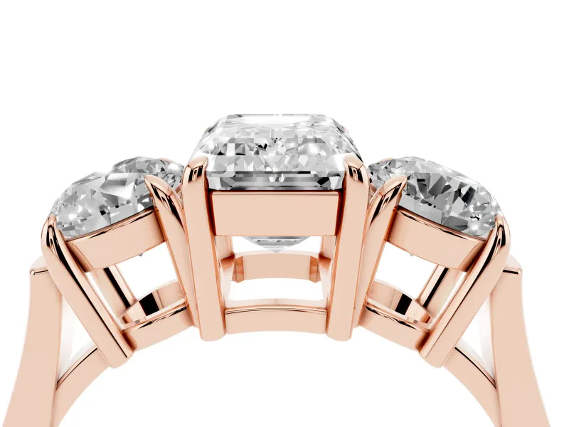 Emerald Cut Diamond Three-Stone Ring Set in Rose gold with Round Accent Stones and Plain Band