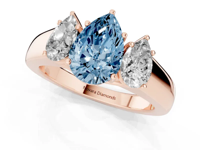 Fancy Blue Three-Stone Pear Cut Diamond Ring Set in Rose gold with Matching Prong Settings and Plain Band