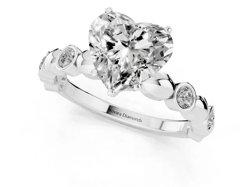 Heart Cut Diamond Solitaire Ring Set in Platinum with Bezel-Set Accents on Beaded Band and Prong Setting