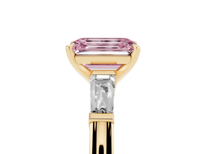 Fancy Pink Emerald Cut Diamond Solitaire Ring Set in Yellow gold with Tapered Baguette Side Stones and Prong Setting