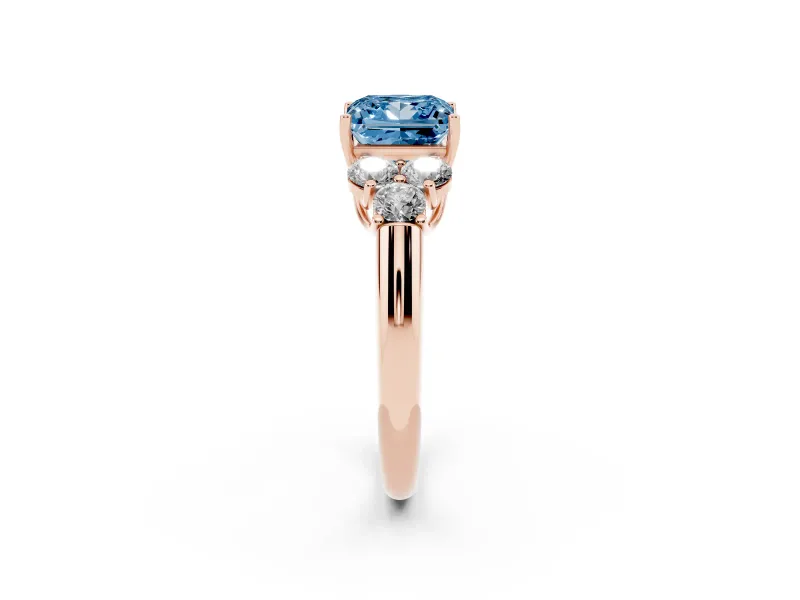 Fancy Blue Princess Cut Diamond Cluster Ring Set in Rose gold with Round Accent Stones and Prong Setting on a Plain Band