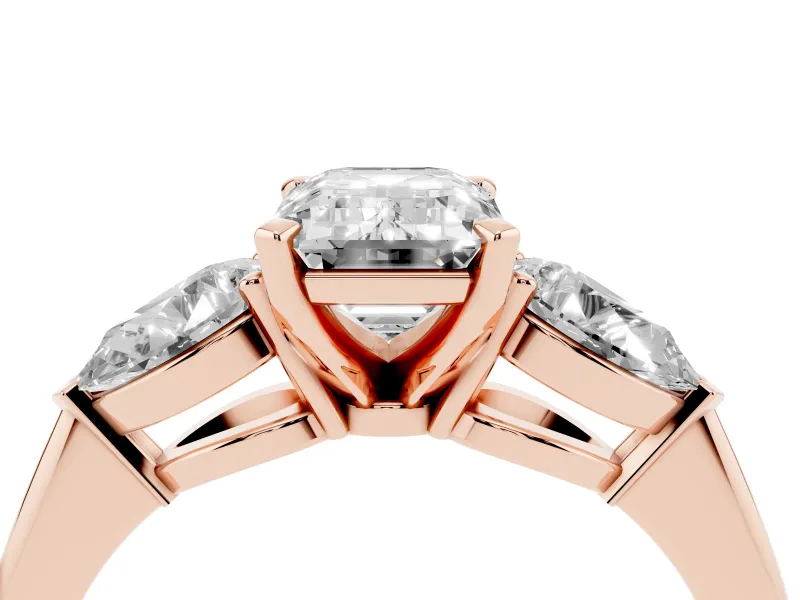 Three-Stone Emerald Cut Diamond Ring Set in Rose gold with Pear Side Stones and Prong Setting