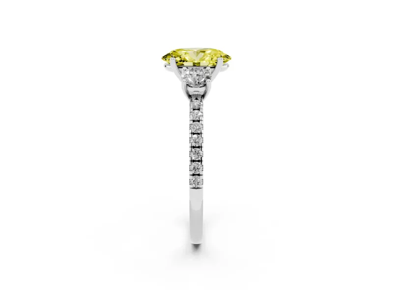 Fancy Yellow Oval Cut Diamond Three-Stone Ring Set in White gold with Pavé Band and Graduated Sides
