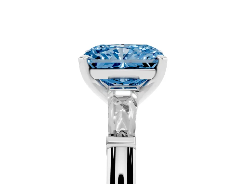 Fancy Blue Radiant Cut Diamond Solitaire Ring Set in Silver with Tapered Baguette Side Stones and Prong Setting