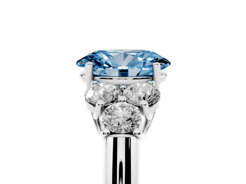 Fancy Blue Oval Cut Diamond Cluster Ring Set in Platinum with Round Accent Stones and Prong Setting on a Plain Band