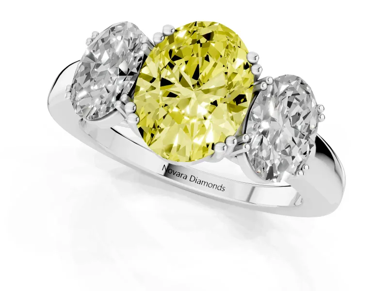 Fancy Yellow Oval Cut Diamond Three-Stone Ring Set in Platinum with Polished Band and Prong Setting