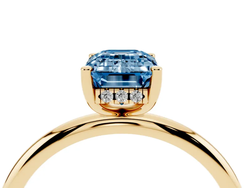 Fancy Blue Emerald Cut Diamond Solitaire Engagement Ring Set in Yellow gold with Prong Setting and Polished Band