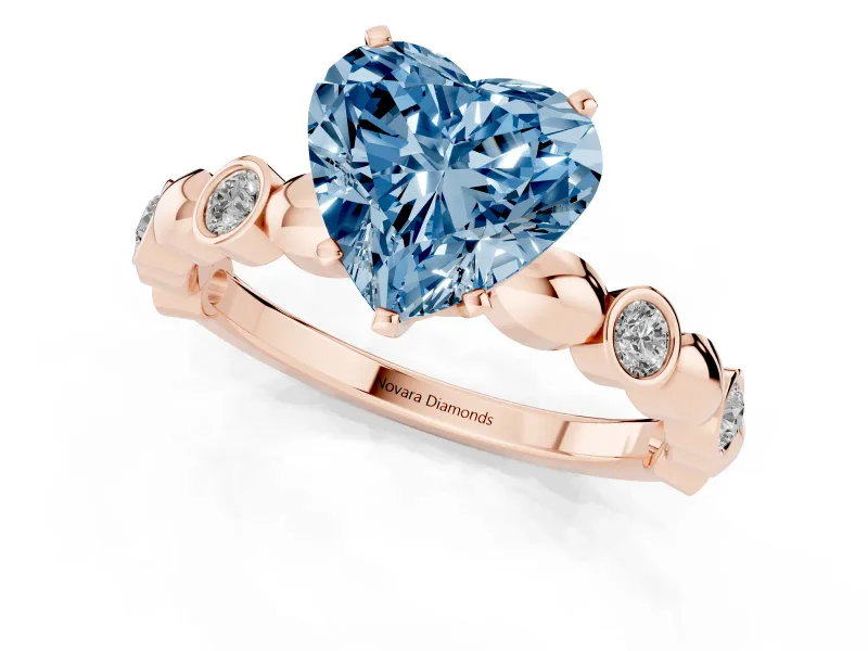Fancy Blue Heart Cut Diamond Solitaire Ring Set in Rose gold with Bezel-Set Accents on Beaded Band and Prong Setting