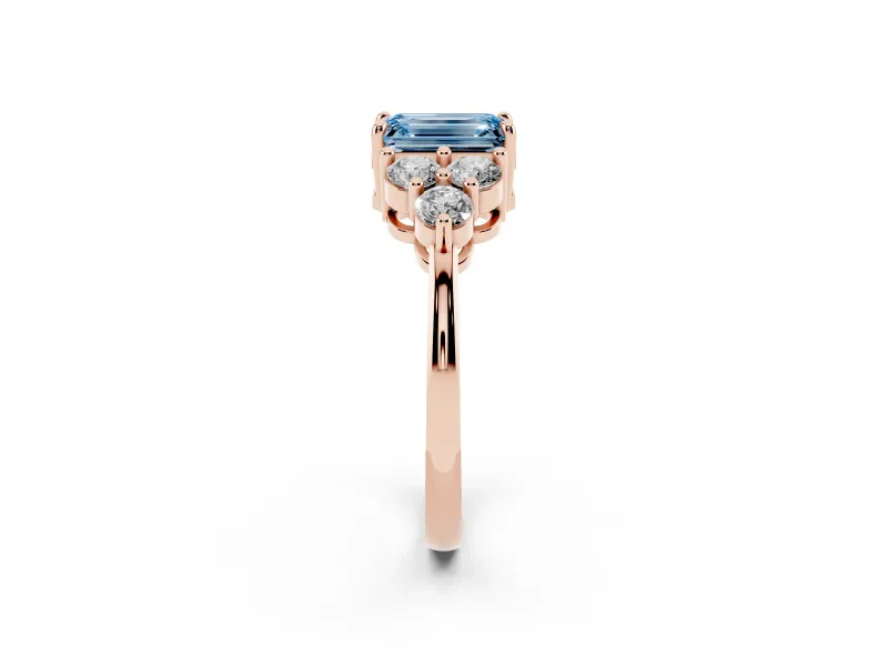 Fancy Blue Emerald Cut Diamond Solitaire Ring Set in Rose gold with Cluster Accents on Each Side