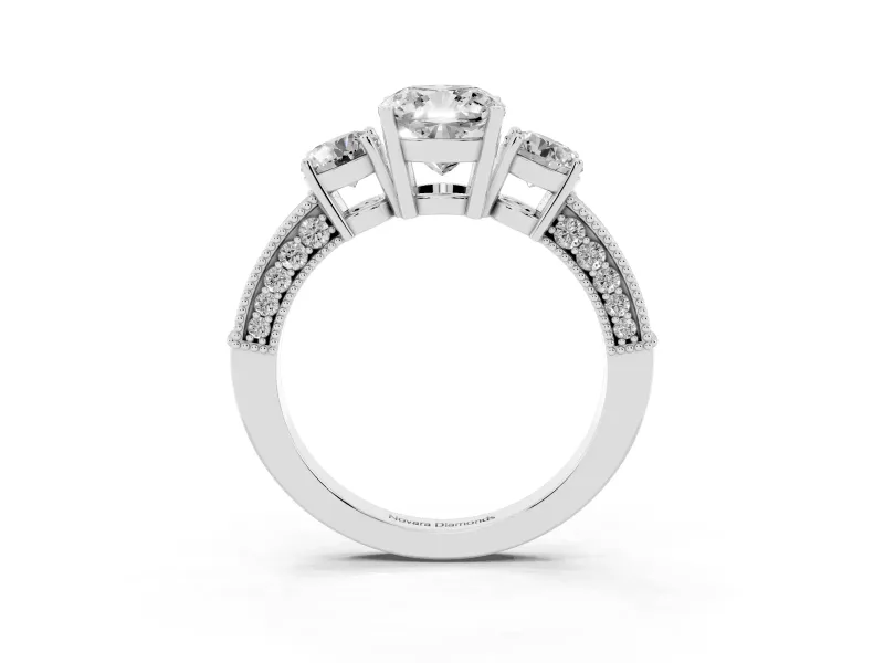 Cushion Cut Diamond Three-Stone Ring Set in Platinum with Round Side Stones and Pavé Band