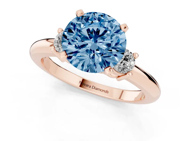 Fancy Blue Three-Stone Round Cut Diamond Ring Set in Rose gold with Prong Setting and Plain Band