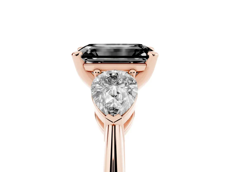 Fancy Black Three-Stone Emerald Cut Diamond Ring Set in Rose gold with Pear Side Stones and Prong Setting