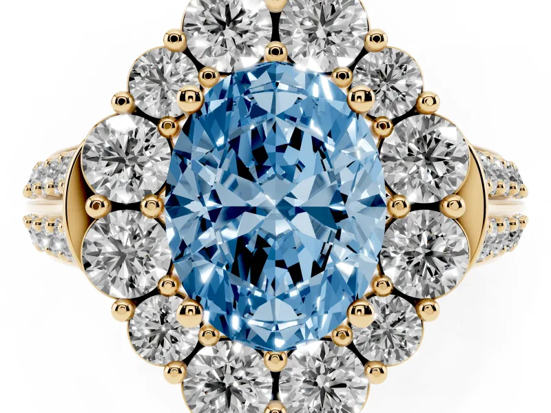 Fancy Blue Oval Cut Diamond Halo Engagement Ring Set in Yellow gold with Split Shank and Prong Setting