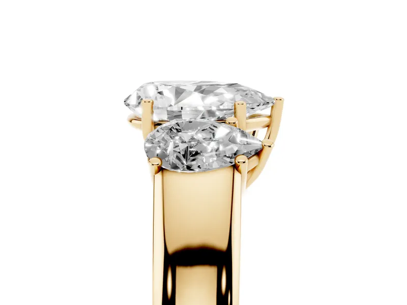 Three-Stone Pear Cut Diamond Ring Set in Yellow gold with Matching Prong Settings and Plain Band