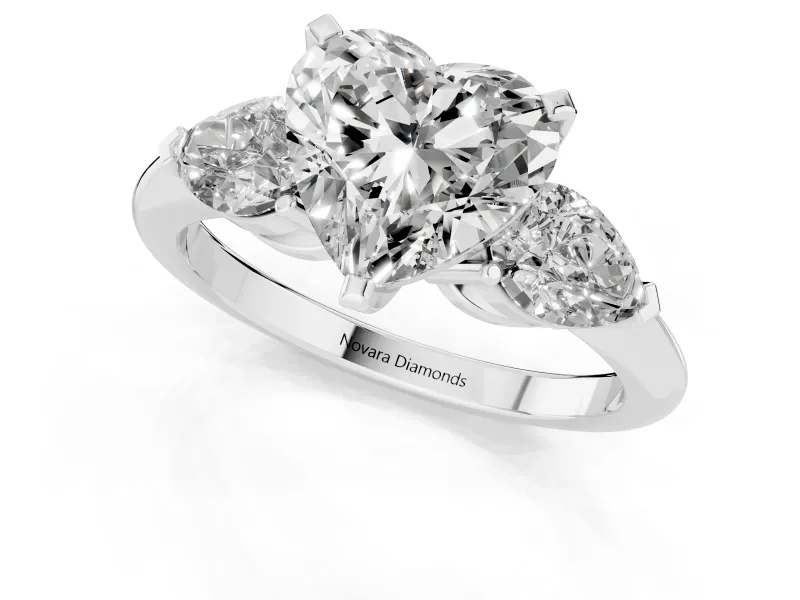 Three-Stone Heart Cut Diamond Ring Set in Platinum with Pear Side Stones and Prong Setting