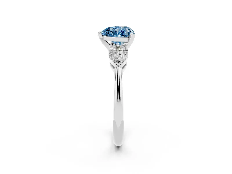 Fancy Blue Three-Stone Heart Cut Diamond Ring Set in Platinum with Pear Side Stones and Prong Setting