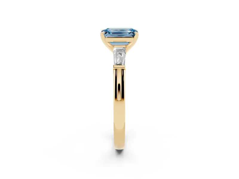 Fancy Blue Emerald Cut Diamond Solitaire Ring Set in Yellow gold with Tapered Baguette Side Stones and Prong Setting