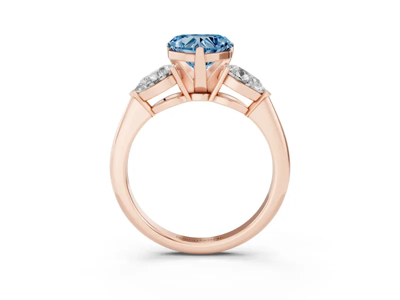Fancy Blue Three-Stone Heart Cut Diamond Ring Set in Rose gold with Pear Side Stones and Prong Setting