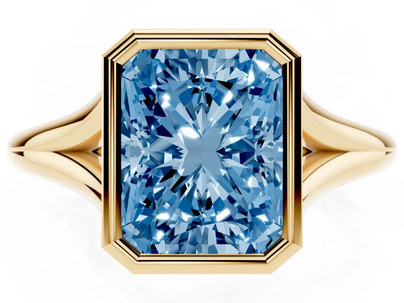 Fancy Blue Bezel Set Radiant Cut Diamond Solitaire Ring Set in Yellow gold with Tapered Band