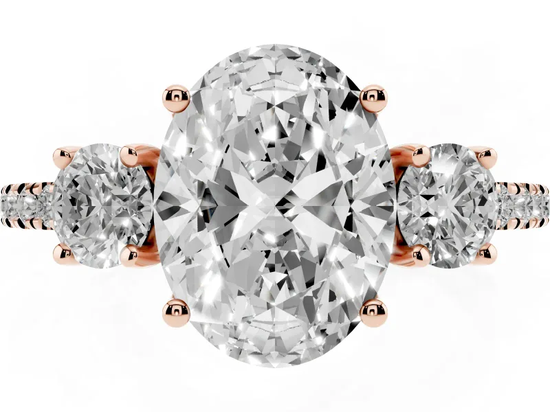 Oval Cut Diamond Three-Stone Ring Set in Rose gold with Pavé Band and Graduated Sides