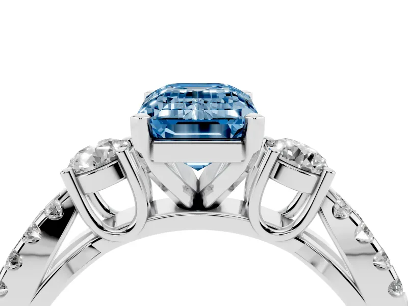 Fancy Blue Emerald Cut Diamond Three-Stone Ring Set in Platinum with Pavé Split Shank and Prong Setting