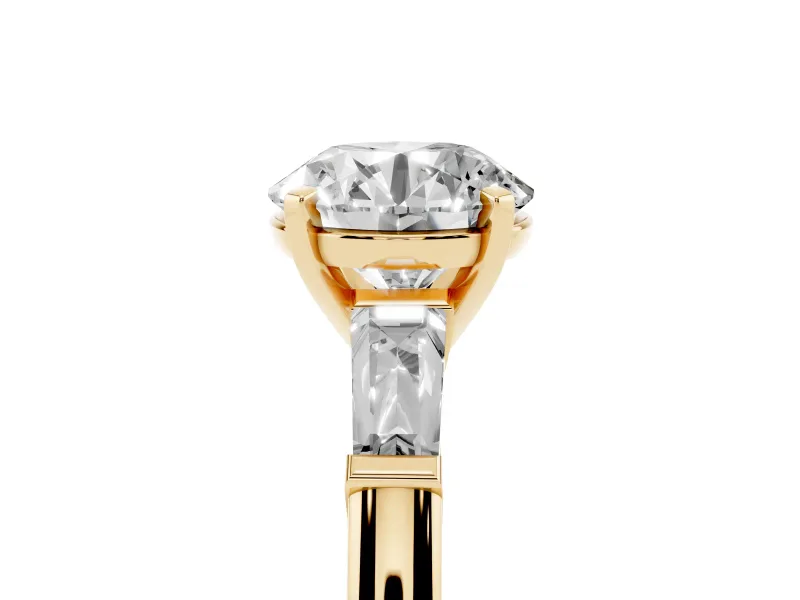 Round Cut Diamond Solitaire Ring Set in Yellow gold with Tapered Baguette Side Stones and Prong Setting