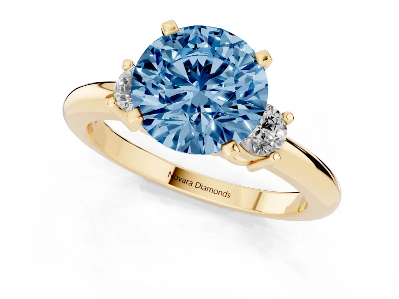 Fancy Blue Three-Stone Round Cut Diamond Ring Set in Yellow gold with Prong Setting and Plain Band
