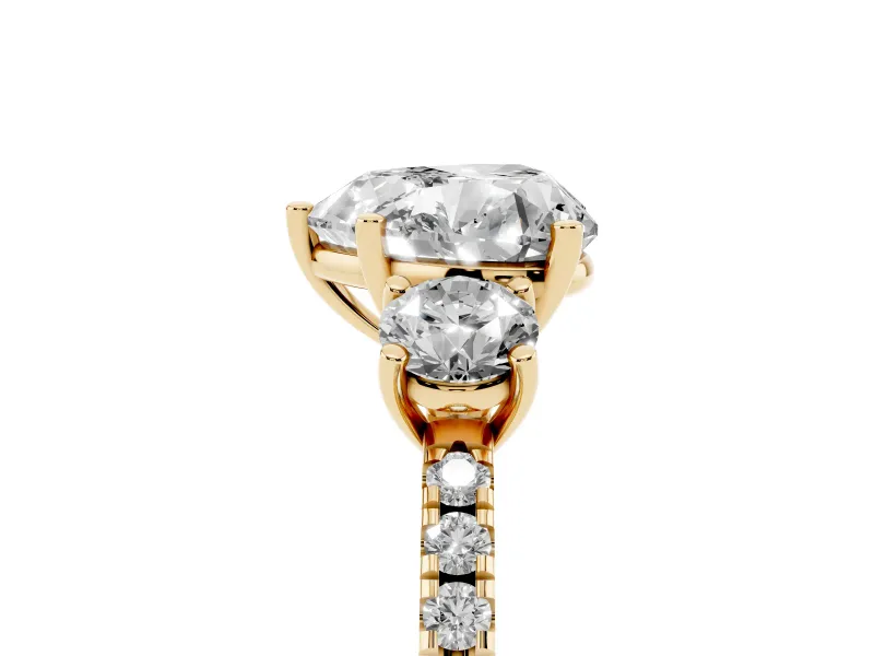 Heart Cut Diamond Three-Stone Ring Set in Yellow gold with Pavé Band and Graduated Sides