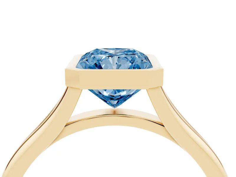 Fancy Blue Bezel Set Radiant Cut Diamond Solitaire Ring Set in Yellow gold with Tapered Band