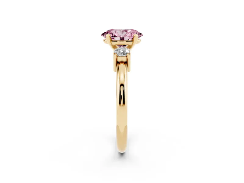 Fancy Pink Three-Stone Oval Cut Diamond Ring Set in Yellow gold with Prong Setting and Plain Band