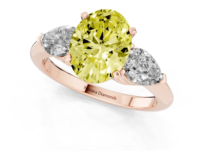 Fancy Yellow Three-Stone Oval Cut Diamond Ring Set in Rose gold with Pear Side Stones and Prong Setting