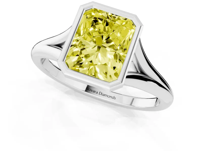 Fancy Yellow Bezel Set Radiant Cut Diamond Solitaire Ring Set in White gold with Tapered Band