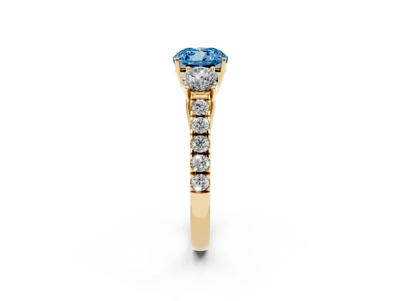 Fancy Blue Cushion Cut Diamond Three-Stone Ring Set in Yellow gold with Round Side Stones and Delicate Pavé Band