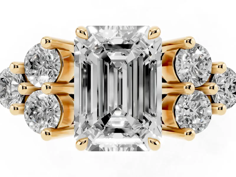 Emerald Cut Diamond Solitaire Ring Set in Yellow gold with Cluster Accents on Each Side