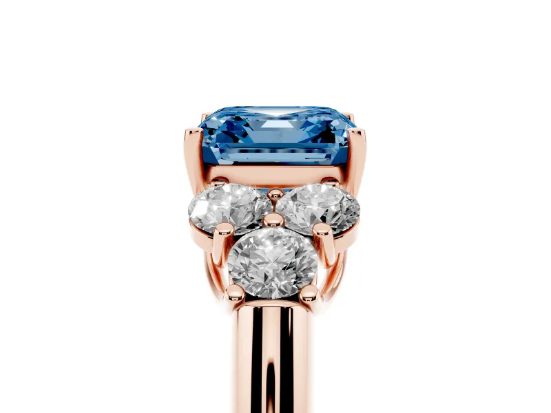 Fancy Blue Asscher Cut Diamond Cluster Ring Set in Rose gold with Round Accent Stones and Prong Setting on a Plain Band