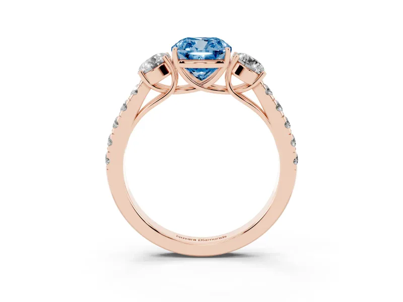 Fancy Blue Cushion Cut Diamond Three-Stone Ring Set in Rose gold with Round Side Stones and Delicate Pavé Band
