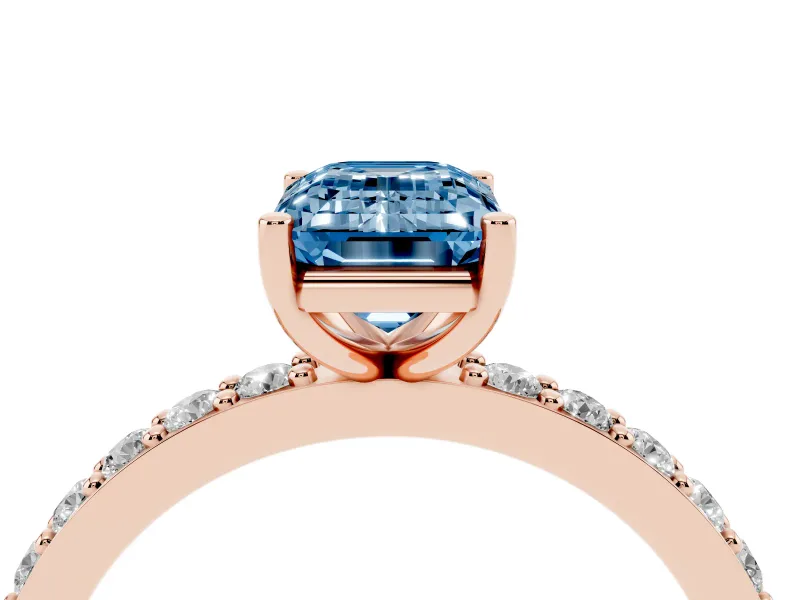 Fancy Blue Emerald Cut Diamond Solitaire Set in Rose gold with Round Pavé Band and Prong Setting