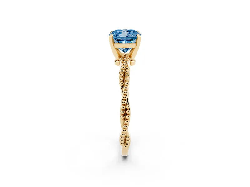 Fancy Blue Cushion Cut Diamond Solitaire Ring Set in Yellow gold with Twisted Band and Bead Prong Setting