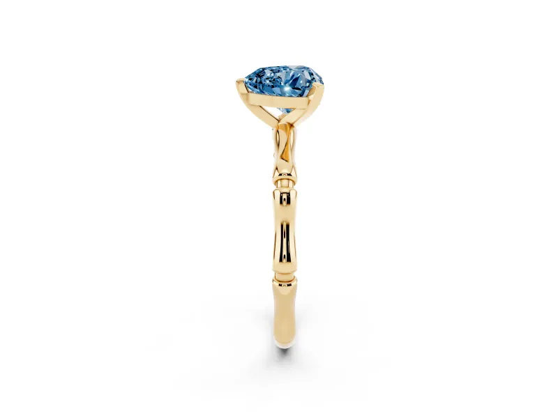 Fancy Blue Heart Cut Diamond Solitaire Ring Set in Yellow gold with Bamboo Band and Prong Setting