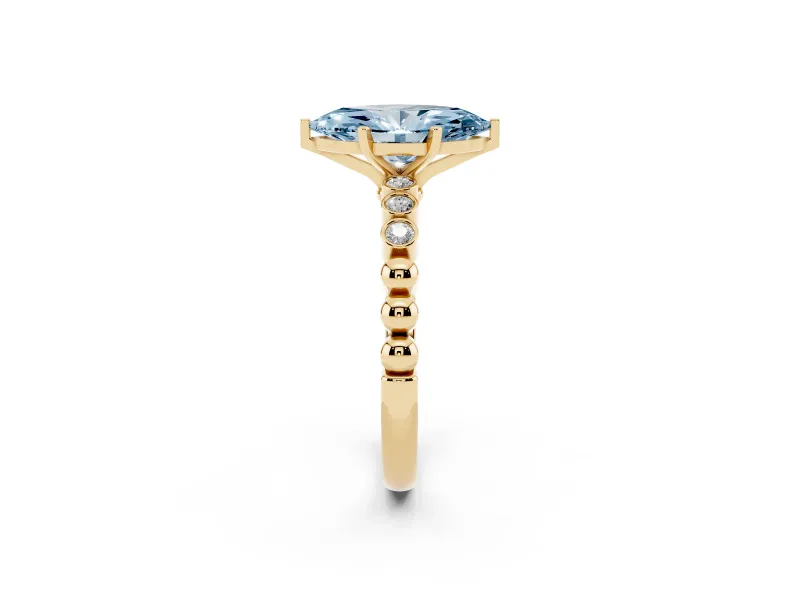 Fancy Blue Marquise Cut Diamond Solitaire Engagement Ring Set in Yellow gold with Bezel Accents on Beaded Band