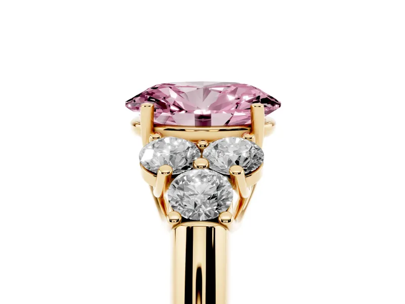 Fancy Pink Oval Cut Diamond Cluster Ring Set in Yellow gold with Round Accent Stones and Prong Setting on a Plain Band