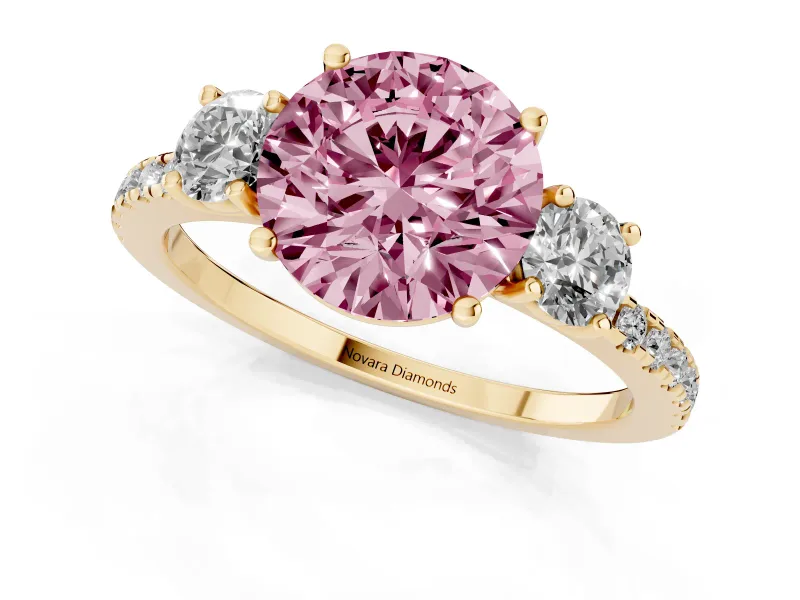 Fancy Pink Round Cut Diamond Three-Stone Ring Set in Yellow gold with Pavé Band and Graduated Sides