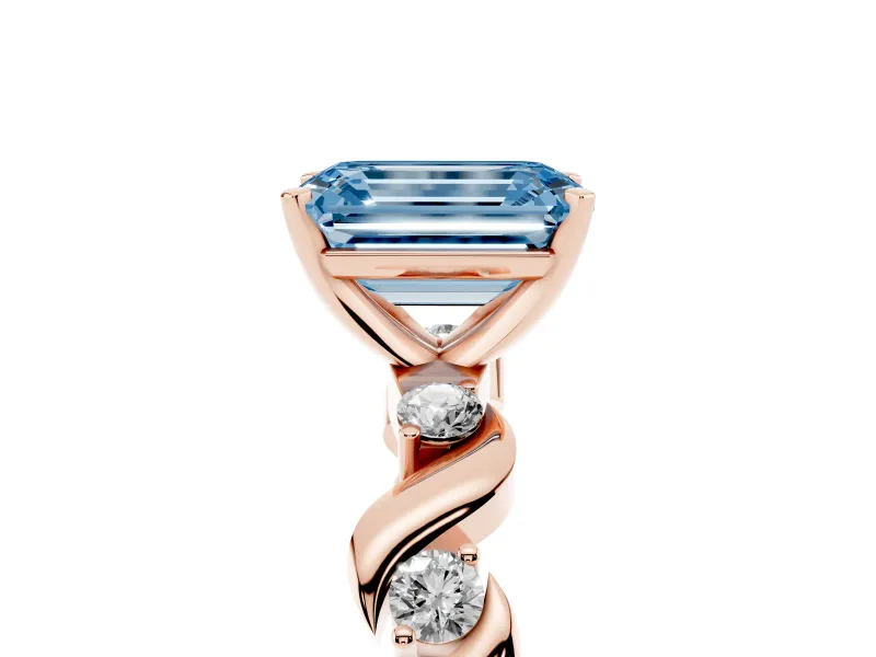 Fancy Blue Emerald Cut Diamond Solitaire Ring Set in Rose gold with Ribbon Twist Band, Round Accents and Prong Setting