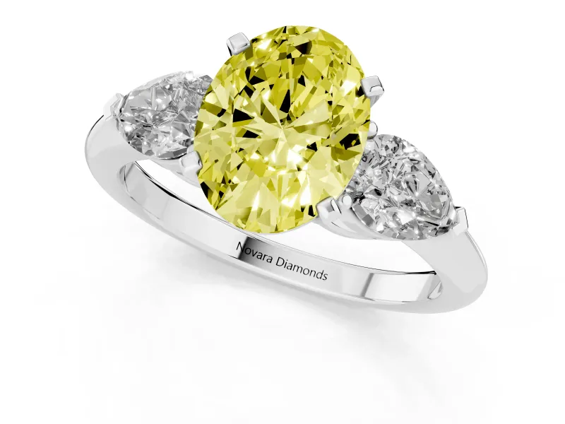 Fancy Yellow Three-Stone Oval Cut Diamond Ring Set in Platinum with Pear Side Stones and Prong Setting