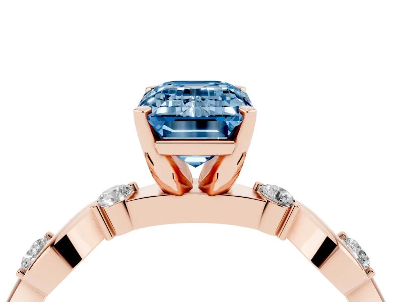 Fancy Blue Emerald Cut Diamond Solitaire Ring Set in Rose gold with Ribbon Twist Band, Round Accents and Prong Setting